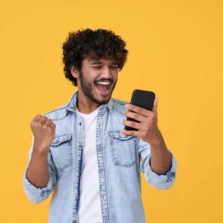 Excited,Happy,Young,Indian,Man,Winner,Feeling,Joy,Using,Smartphone