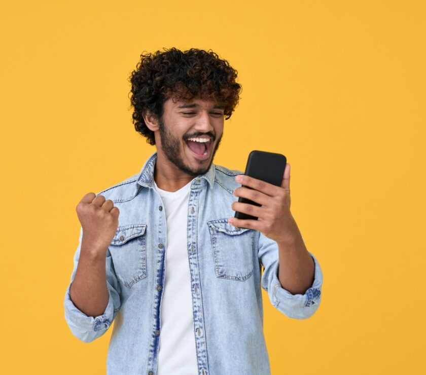 Excited,Happy,Young,Indian,Man,Winner,Feeling,Joy,Using,Smartphone